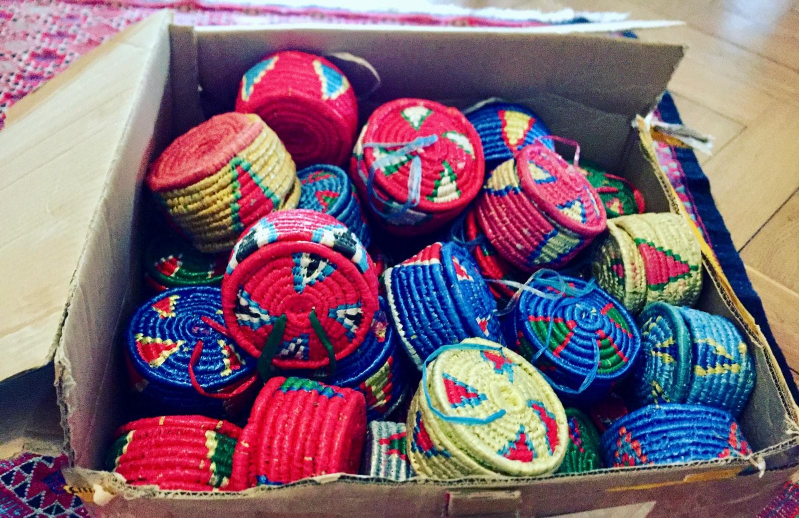 A box full of colourful woven baskets