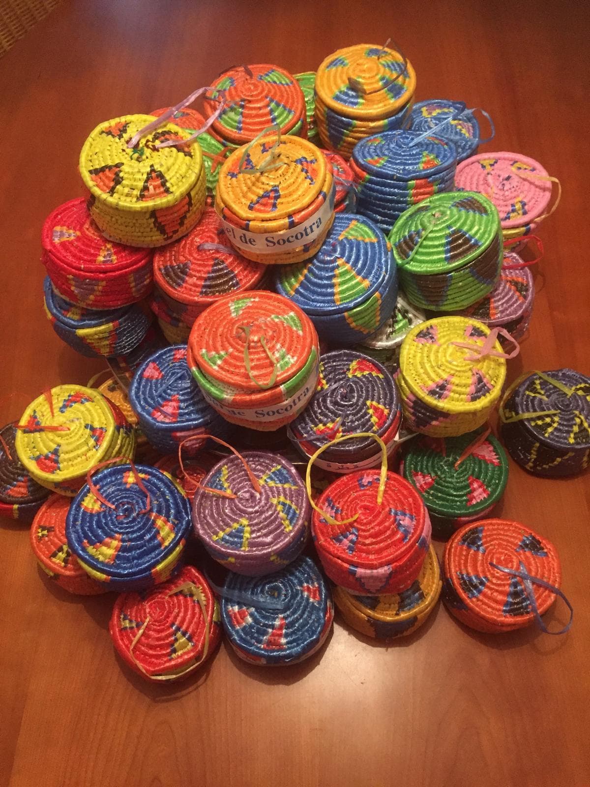 A pile of colourful woven salt baskets