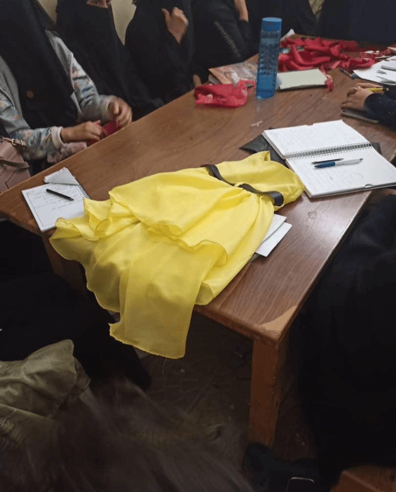 Yellow fabric on the classroom table, in progress